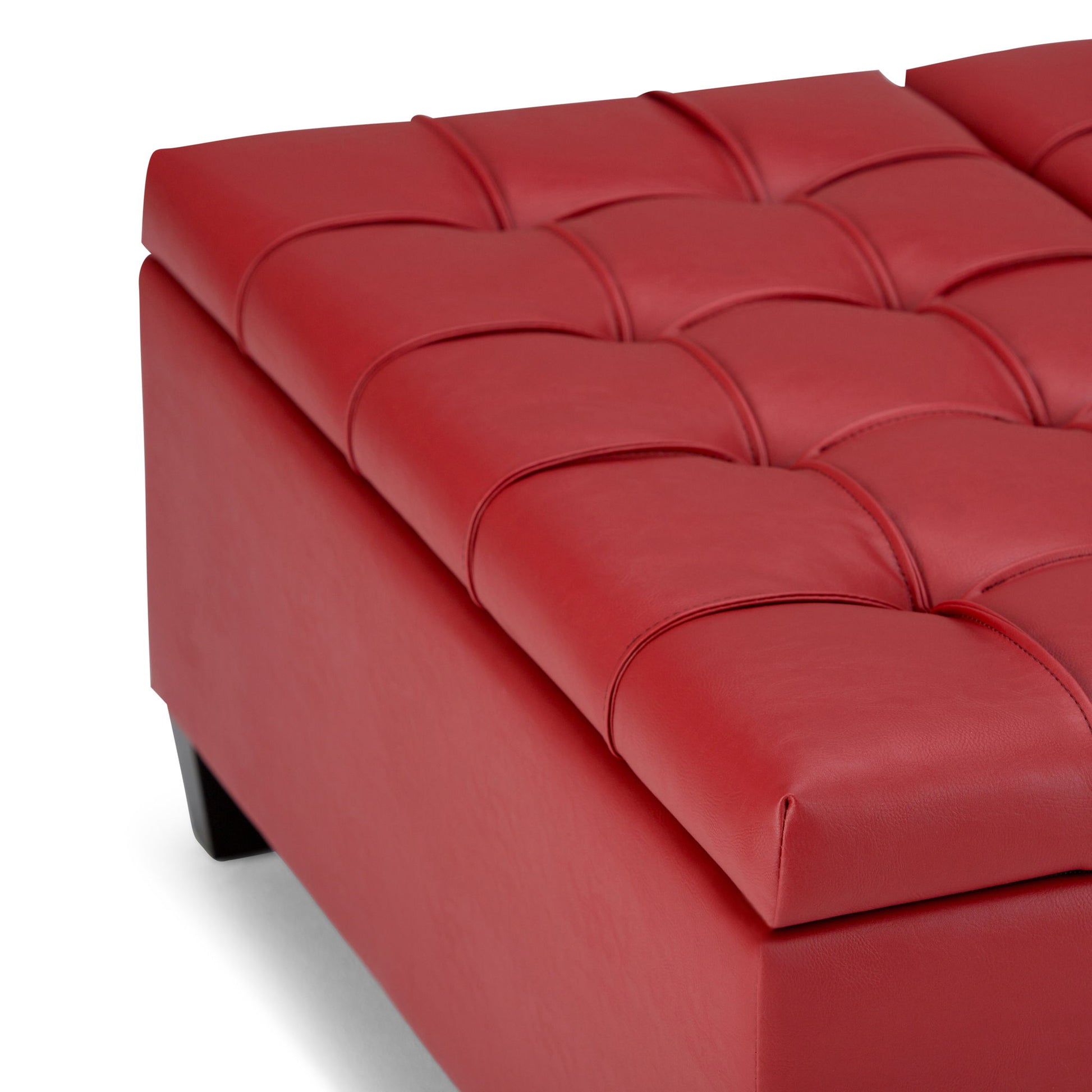 Close-up of the Harrison - Upholstered Coffee Table Storage Ottoman in modern red leather with a tufted cushioned top and short black legs, shown against a white background.