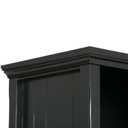 Close-up of the upper corner of the Acadian - Handcrafted Cube Storage, featuring black wood with decorative crown molding and vertical grooves on the side panel.