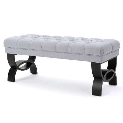 The Hilton - Ottoman Bench Classic Style features a tufted light gray upholstered cushion and curved black wooden legs, shown against a white background.