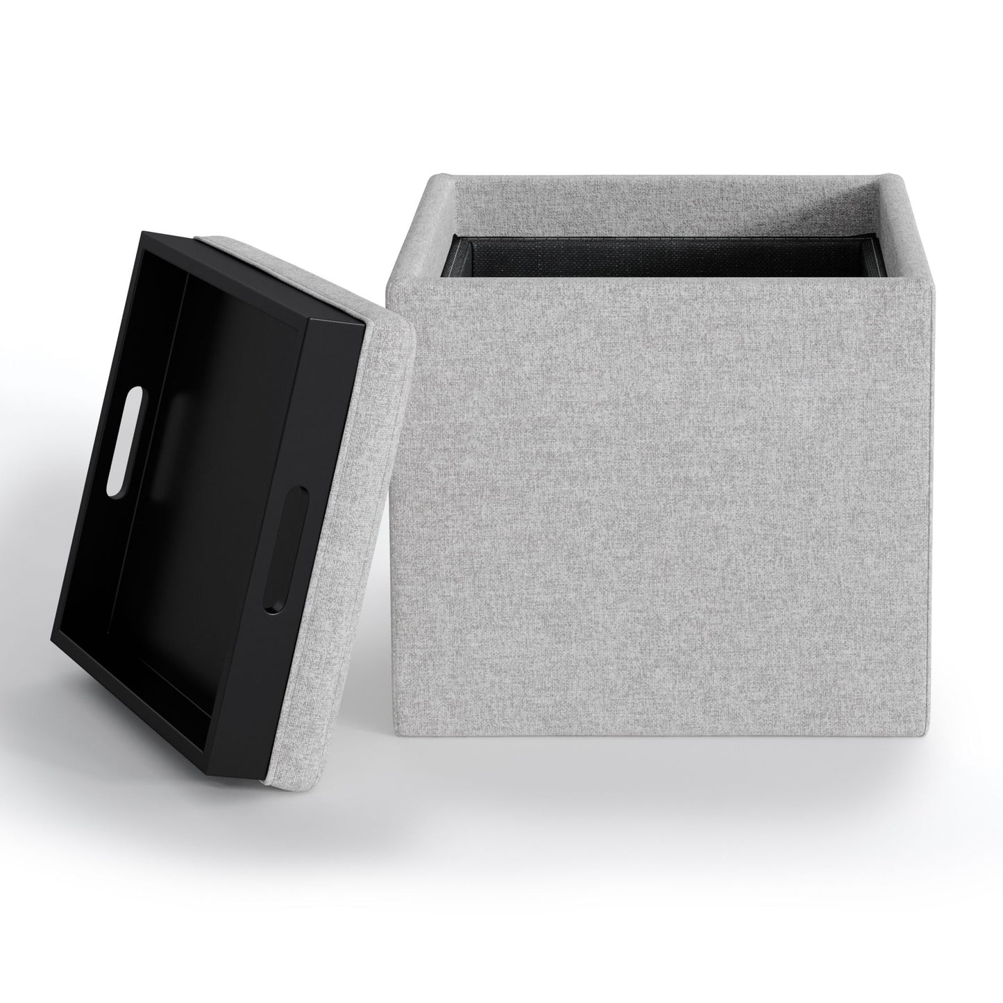 The Rockwood Upholstered Cube Storage Ottoman With Tray is shown with its black, handled tray-style lid off and leaning against it, revealing the empty, light gray fabric interior. Set against a white background.