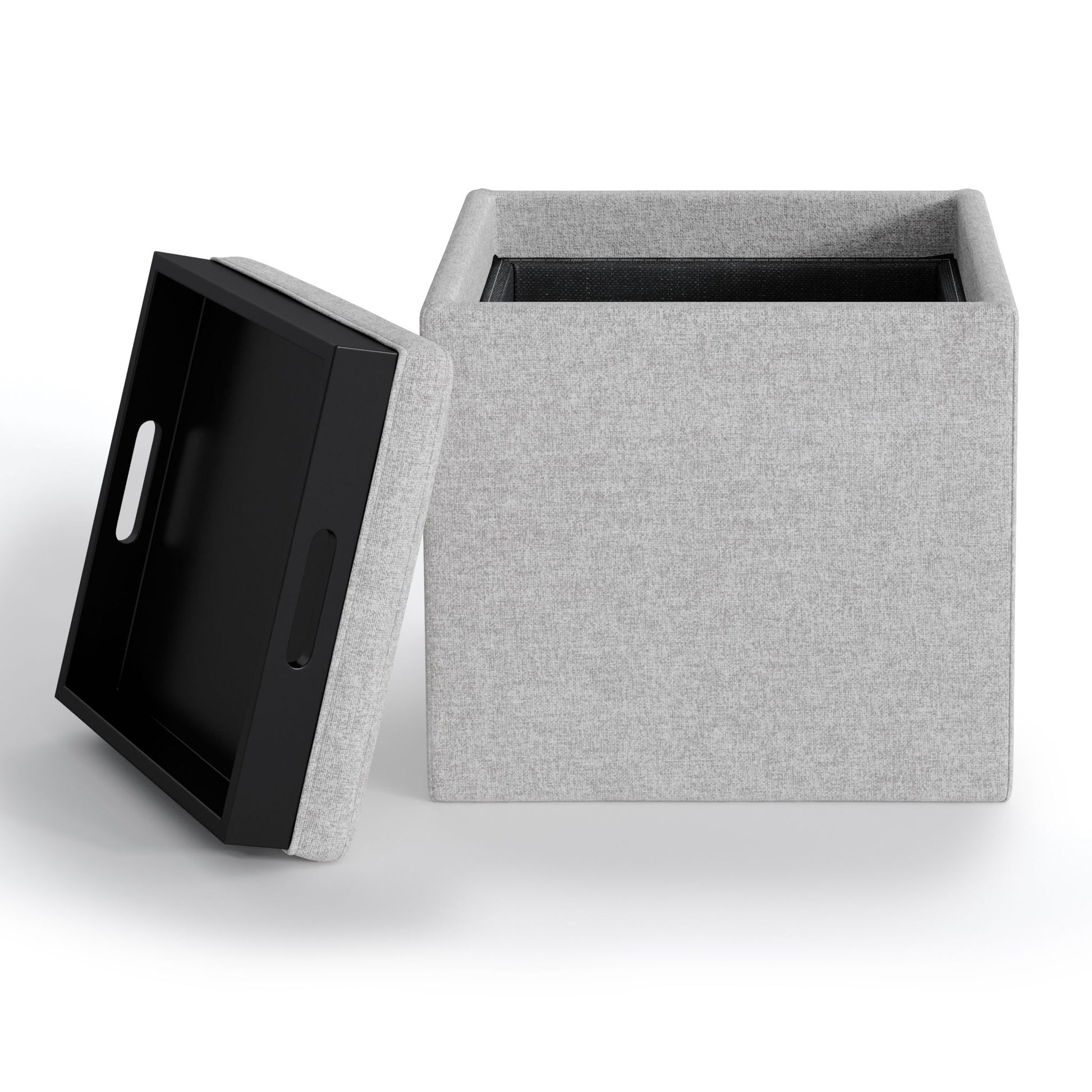 The Rockwood Upholstered Cube Storage Ottoman With Tray is shown with its black, handled tray-style lid off and leaning against it, revealing the empty, light gray fabric interior. Set against a white background.