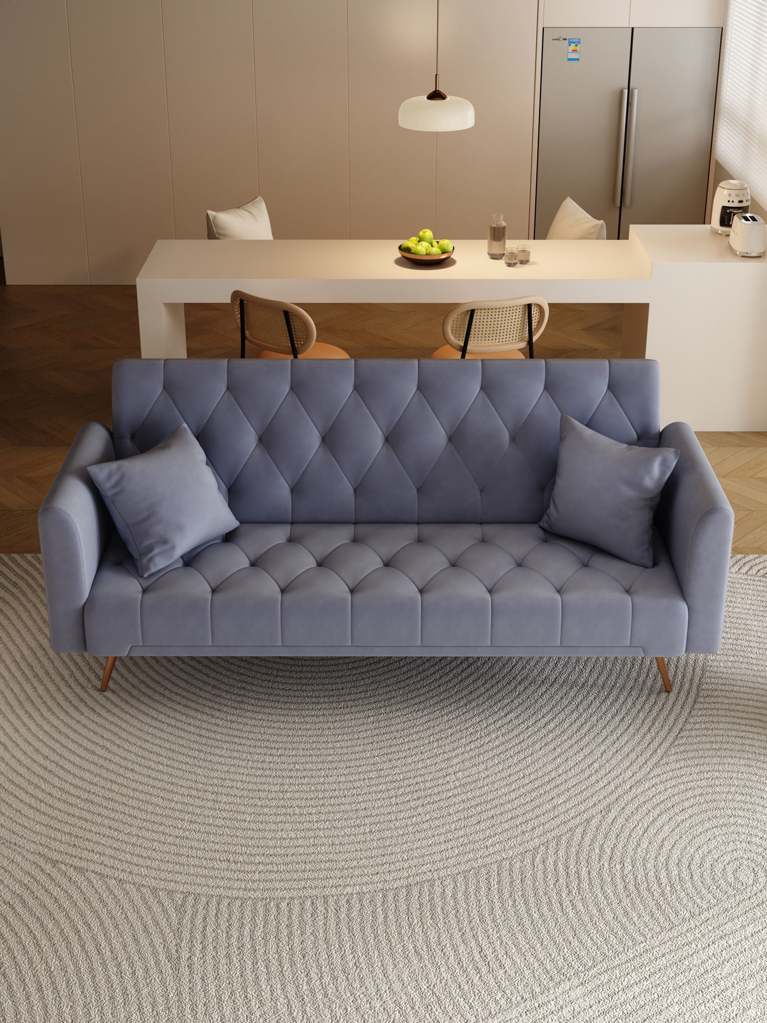A modern living room features a Convertible Double Folding Living Room Sofa Bed in blue-gray with two cushions on a textured circular rug. Behind it, there’s a dining table with chairs, a hanging light, and a refrigerator.