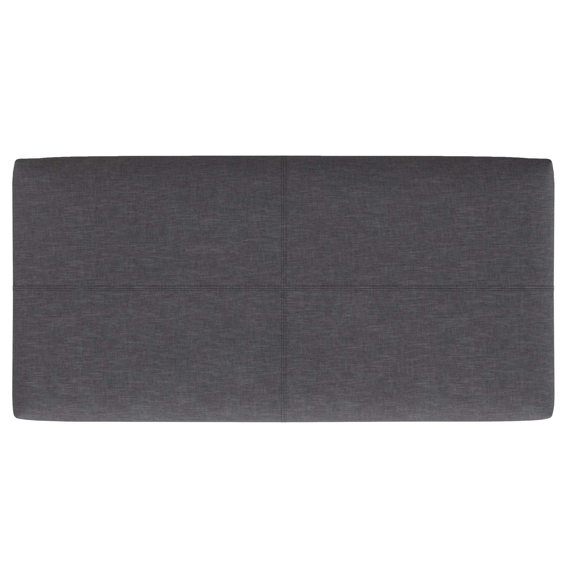 The Gabbie Coffee Table Upholstered Storage Ottoman features a rectangular shape, dark gray upholstery, and a simple, modern design with subtle horizontal and vertical seams dividing its surface into four sections.