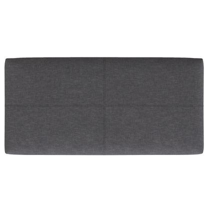 The Gabbie Coffee Table Upholstered Storage Ottoman features a rectangular shape, dark gray upholstery, and a simple, modern design with subtle horizontal and vertical seams dividing its surface into four sections.