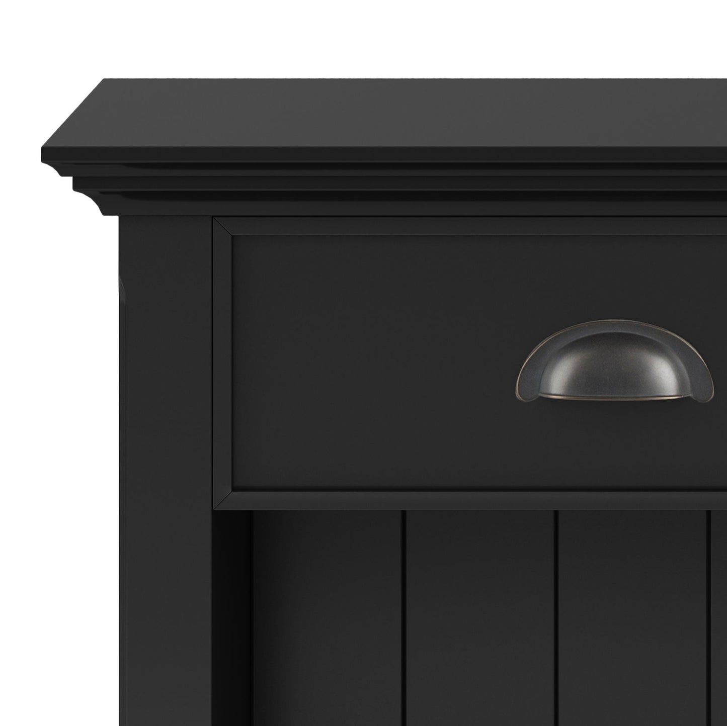 Close-up of the top corner of the Acadian - Bedside Table, Handcrafted, in black wood. Features a drawer with a dark metal cup pull handle and vertical panel detailing below.