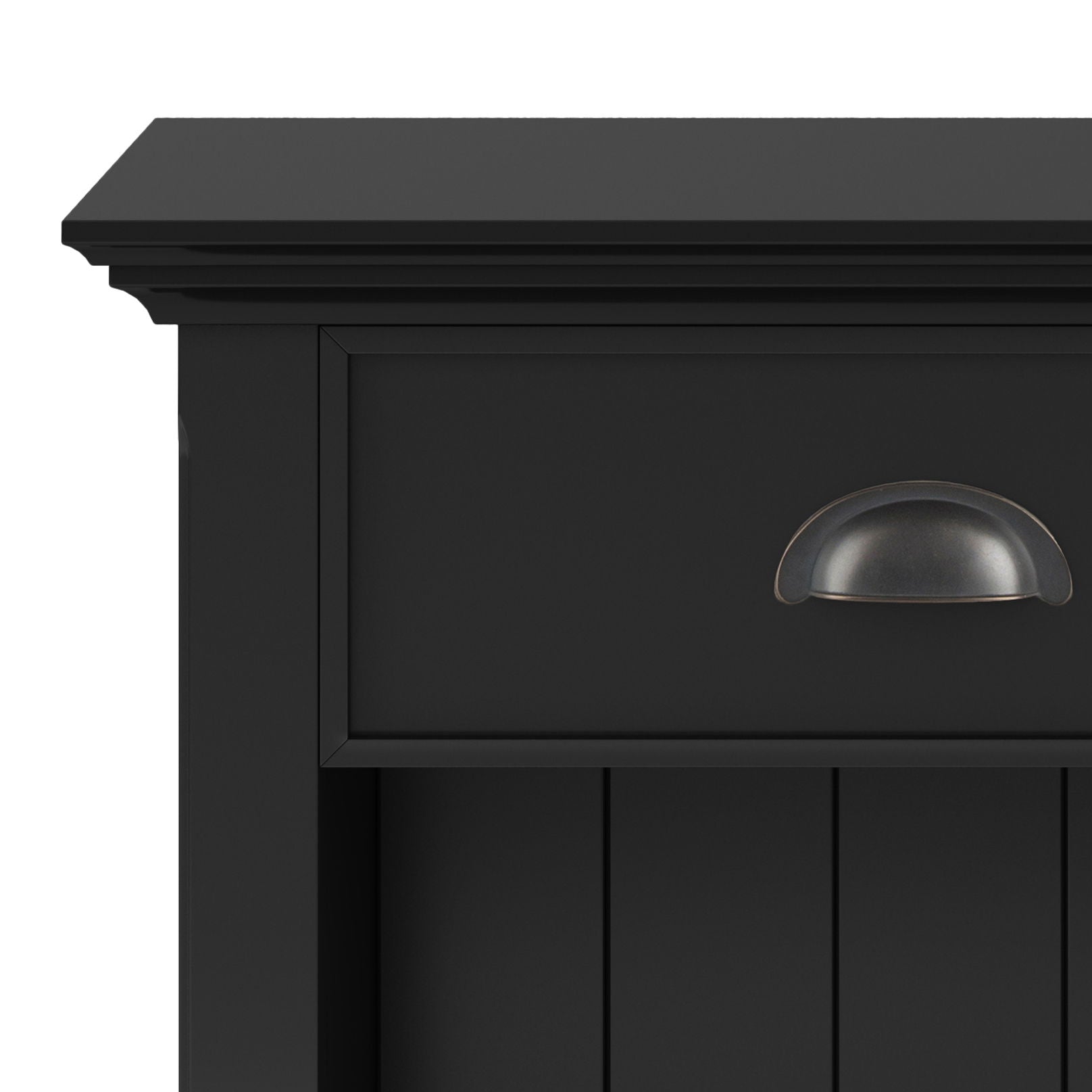Close-up of the top corner of the Acadian - Bedside Table, Handcrafted, in black wood. Features a drawer with a dark metal cup pull handle and vertical panel detailing below.
