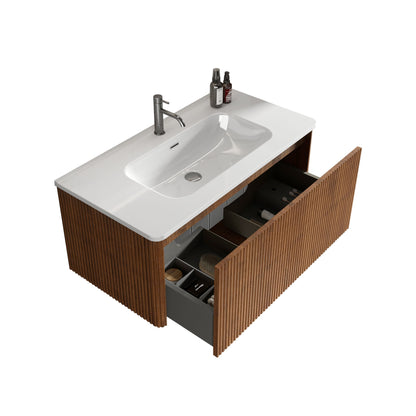 The Etna Striped Wall-Mounted Bathroom Vanity features a modern wood slat design, white ceramic sink, single faucet, two countertop bottles, and an open drawer with organized toiletries for a stylish and functional bathroom.