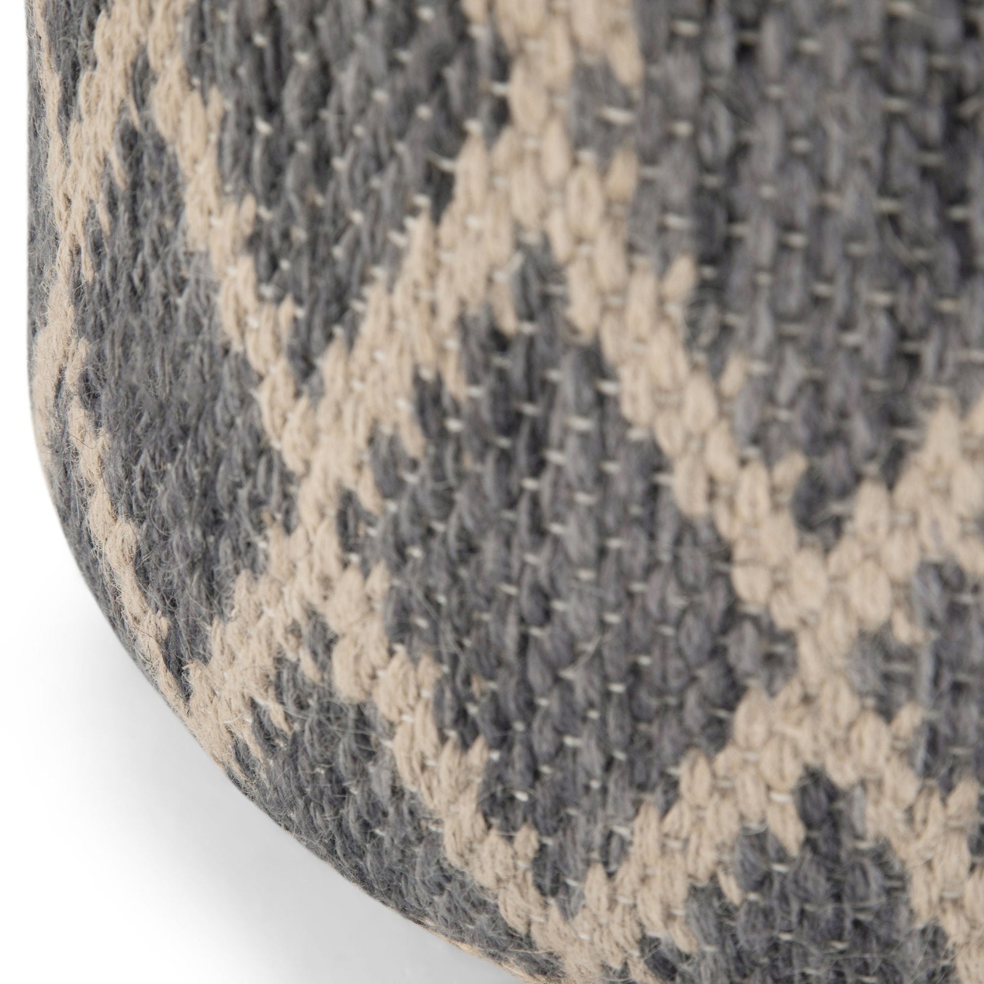 Close-up of the Edgeley - Handcrafted Round Pouf, showing its thick, sturdy woven fabric in a gray and beige crisscross diamond pattern.
