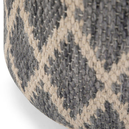 Close-up of the Edgeley - Handcrafted Round Pouf, showing its thick, sturdy woven fabric in a gray and beige crisscross diamond pattern.