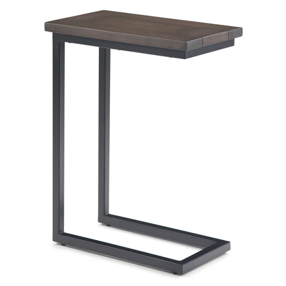 The Skyler - C Side Handcrafted Table features a dark wooden top and black metal frame in a modern C-shape, designed to conveniently slide under sofas or chairs for space-saving functionality.