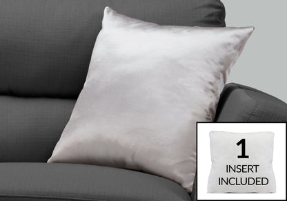A square light gray decorative throw pillow (insert included, hypoallergenic) sits on a dark gray sofa. An inset shows another pillow with “1 INSERT INCLUDED” to highlight the included insert.