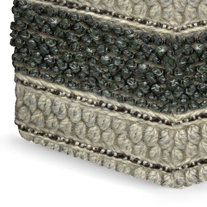 Close-up of the Grady Handcrafted Square Pouf shows its woven texture, featuring alternating thick cream and dark green fibers in a striped, knotted pattern.