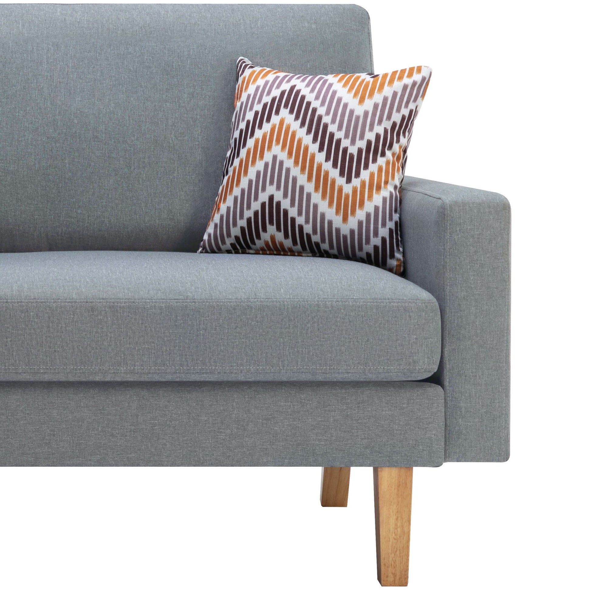 The Bahamas - Minimalistic Sofa With 2 Throw Pillows is a modern light gray sofa with wooden legs, shown in profile, featuring a decorative pillow with an orange, brown, and gray zigzag pattern against the armrest.