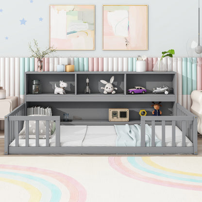 A tidy children’s room features the Floor Bed With Bedside Bookcase, Shelves, Guardrails in gray, filled with toys and books. Soft pastel wall art and a rainbow rug create a playful and cozy atmosphere.
