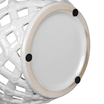 Close-up of the base of the Ceramic Lidded Jar With Lattice Design - White, featuring a round bottom with three small black pads that help protect surfaces from scratches.
