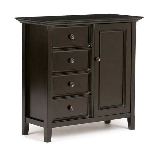 The Amherst - Handcrafted Medium Storage Cabinet is a dark wood piece with four left-side drawers and a right-side door, all with round metal knobs. It stands on short legs and features a simple, classic design.