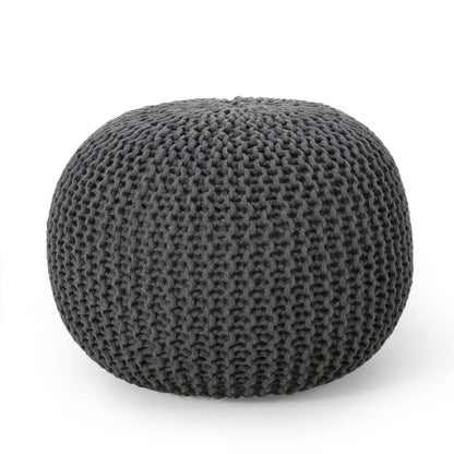 The Bordeaux Knitted Cotton Round Pouf is a dark gray ottoman with a chunky knit texture, perfect as a versatile floor cushion or seat, shown here against a plain white background.