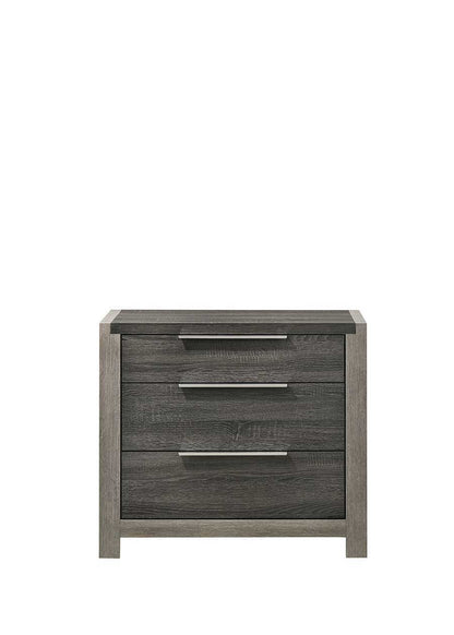The Jehoram Nightstand in gray features a modern design with dark gray wood, three spacious horizontal drawers, and sleek metal handles, shown against a plain white background.