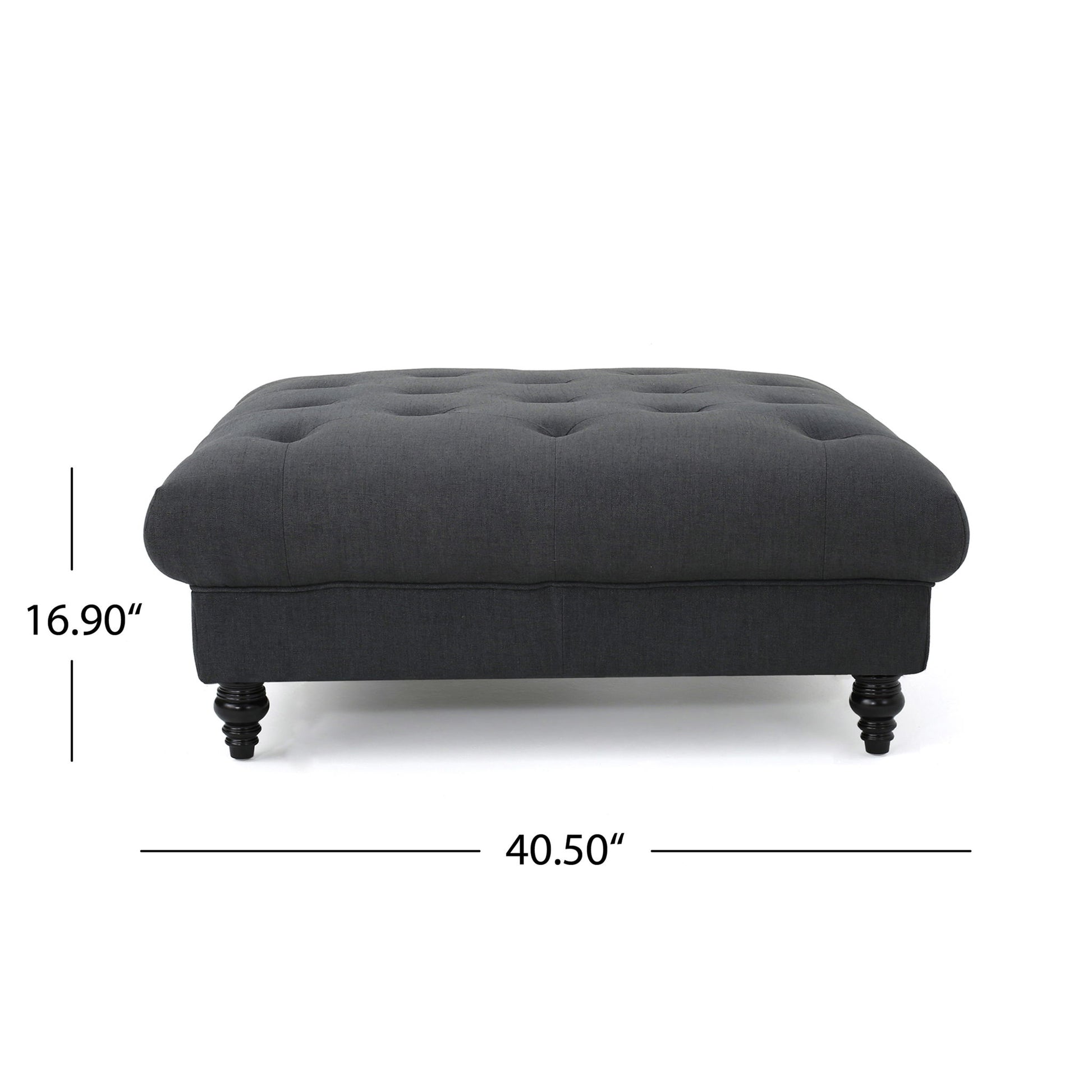 The Madrid Tufted Ottoman Footrest features a dark gray upholstered design, tufted top, wooden legs, and measures 16.9 inches tall by 40.5 inches wide.