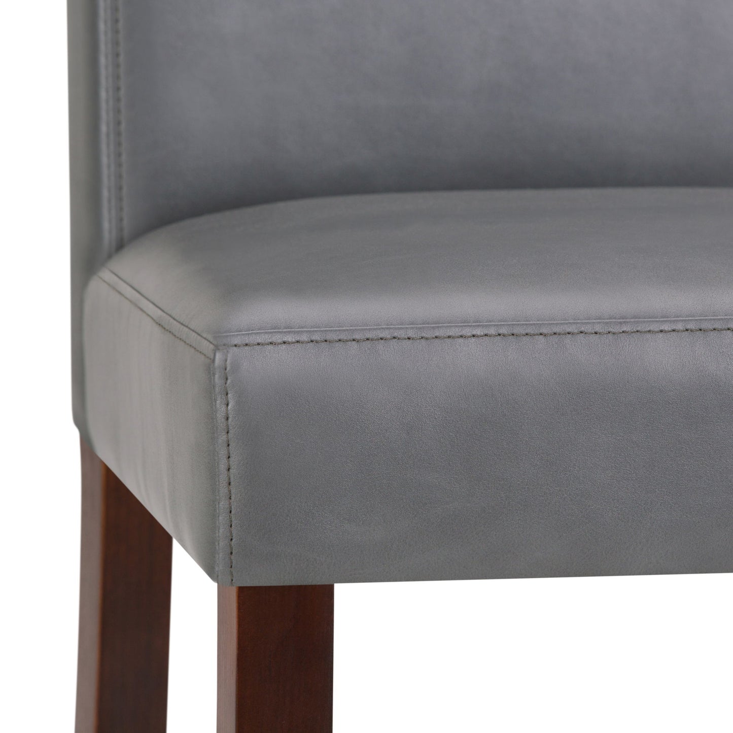 Close-up of the Acadian - Upholstered Parson Dining Chair, featuring a smooth gray upholstered seat and seatback with visible stitching, and straight dark wooden legs. Sold as a set of 2.