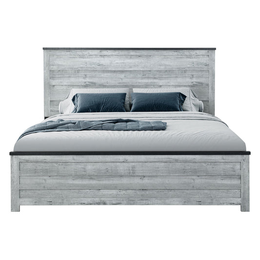 The Kicks - 5 Pieces Bedroom Set features a modern bed with a rustic, light gray wooden frame and headboard, styled with white bedding, blue and gray pillows, and a blue textured throw.