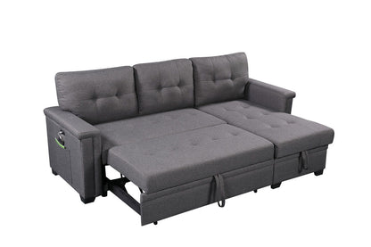 The Ashlyn Reversible Sleeper Sectional Sofa with storage chaise, USB charging ports, and pocket is shown extended as a bed against a white background, highlighting its gray upholstery and tufted cushions.