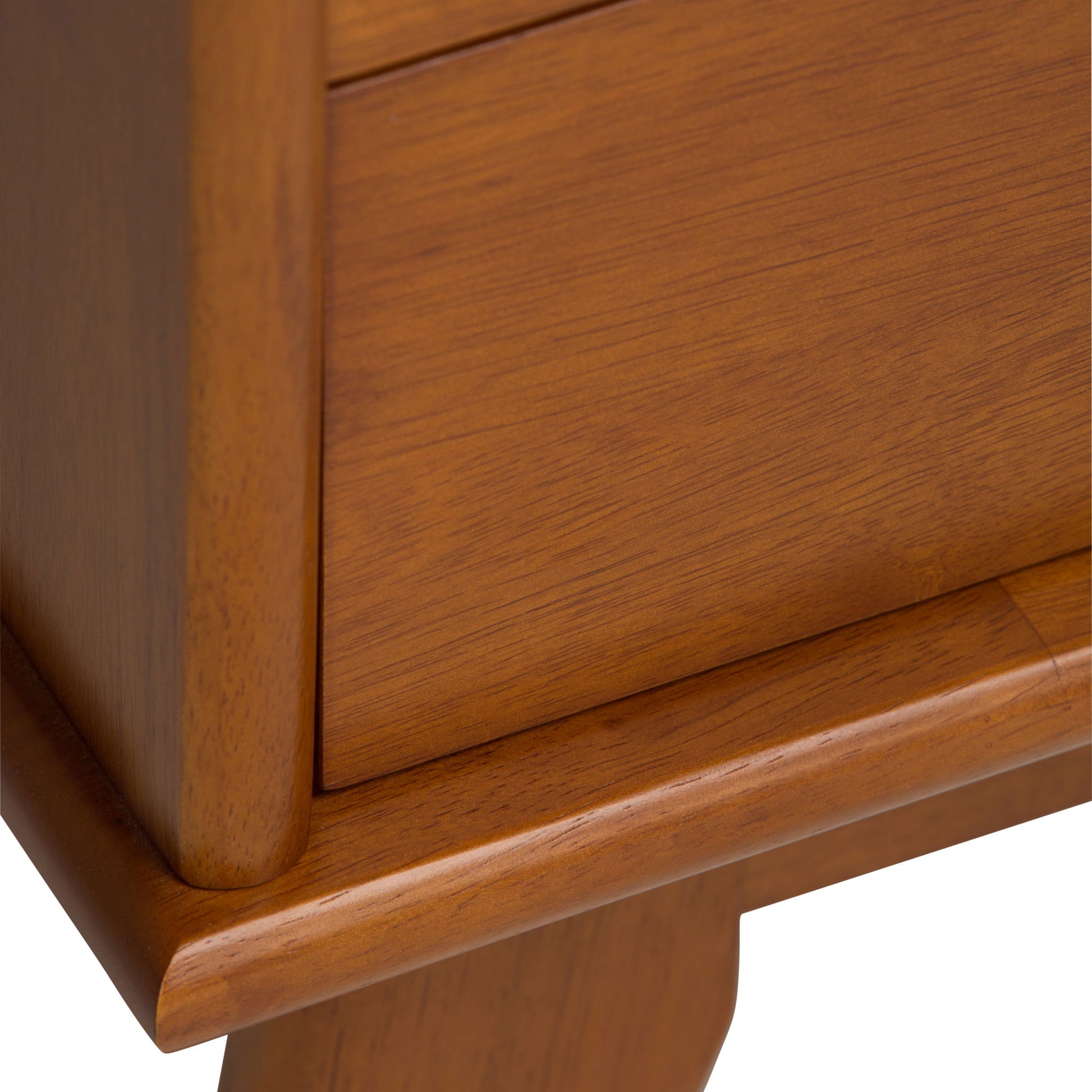 Close-up of the Draper - Mid Century Wide Bookcase And Storage Unit, highlighting its warm brown wood tone, visible grain patterns, smooth polished finish, drawer detail, and the corner of its leg.