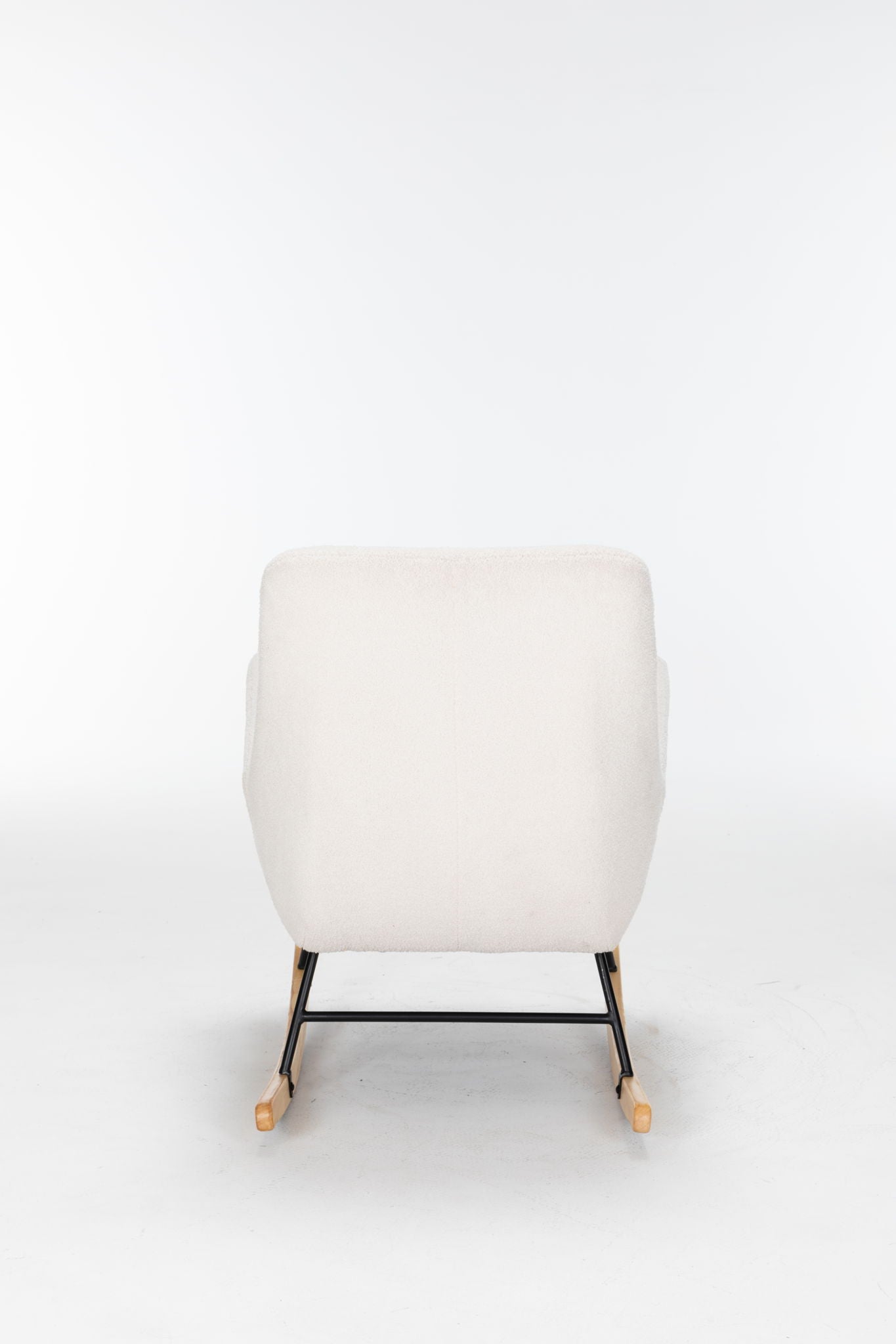 The Rocking Chair Nursery, Teddy Upholstered Glider Rocker in cream features a high backrest, modern design, and sturdy wooden rockers with black metal supports. Shown from the front against a plain white background.