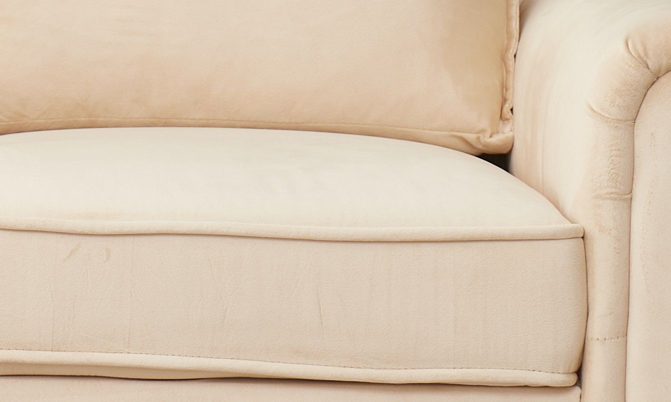 Close-up of the Graceful Design Plush Comfort Loveseat’s beige upholstered cushion with matching backrest and armrest, highlighting its soft fabric texture and plush padding.