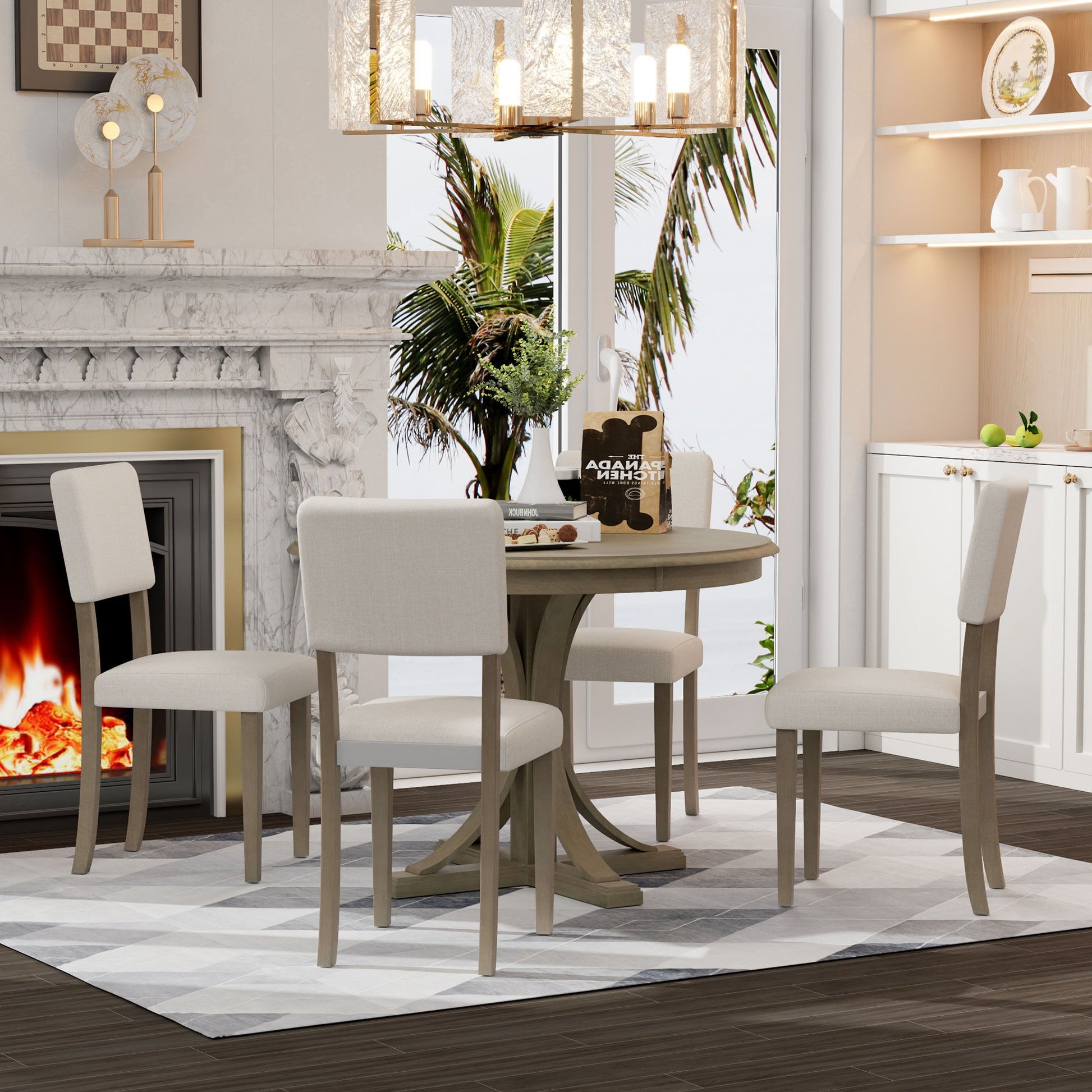 A cozy dining room features the Retro Round Dining Table Set with curved trestle-style legs and upholstered chairs, centered with a plant. A lit fireplace and a window with palm trees outside add warmth and brightness to the elegant space.