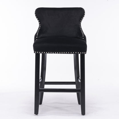 Set of 2 Contemporary Velvet Upholstered Wing-Back Barstools with button-tufted decoration, chrome nailhead trim, wooden legs with footrests, and leisure style design, shown on a plain white background.