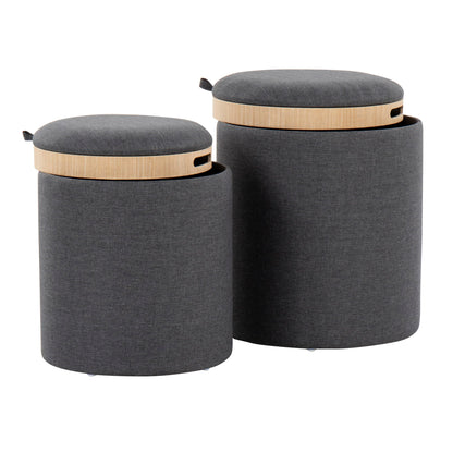 The Tray - Contemporary Nesting Ottoman Set features two modern, cylindrical dark gray fabric ottomans in different sizes. Each has a light wood removable lid with small handles for easy lifting and convenient storage.