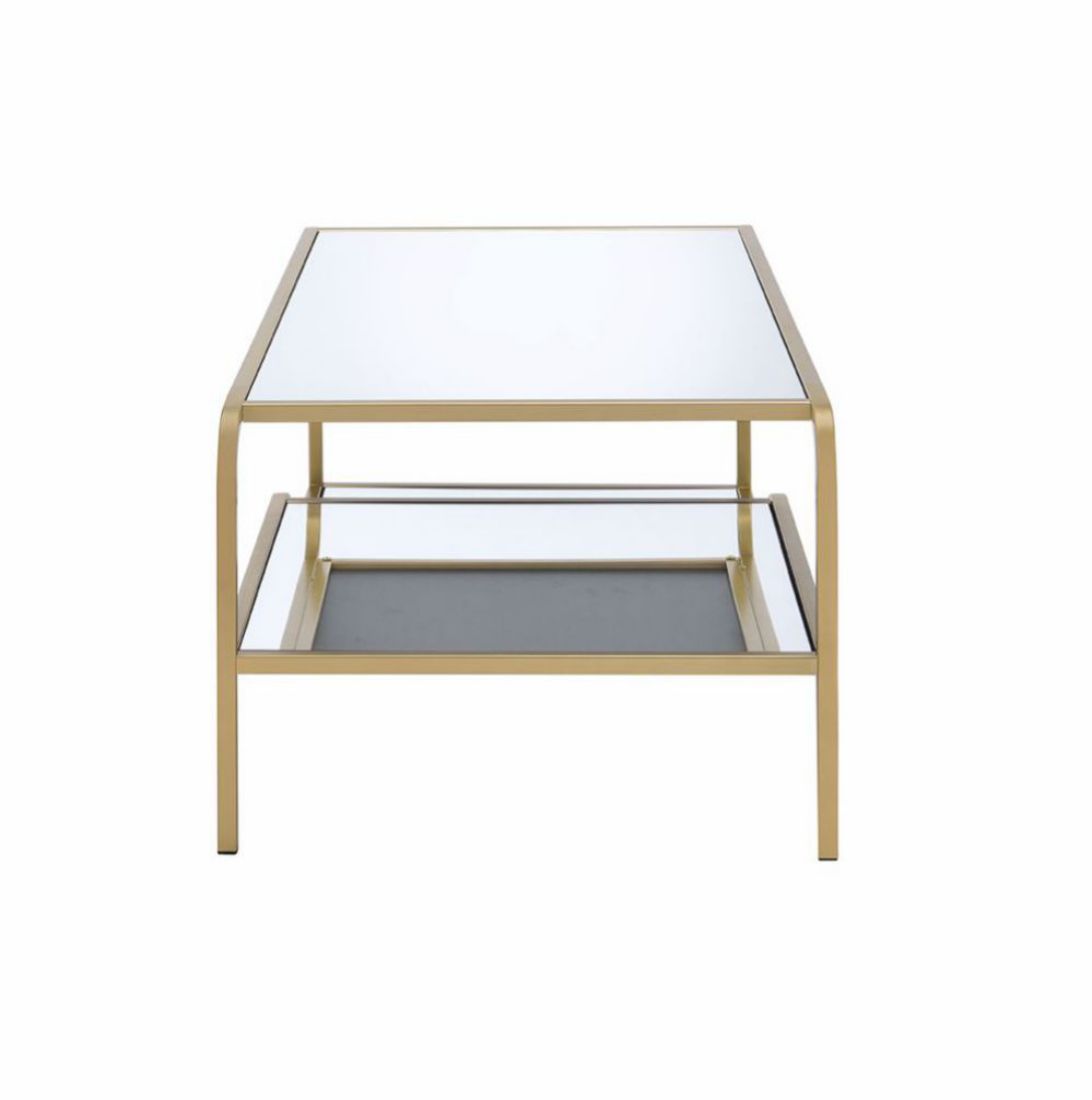 The Astrid - Mirrored Table features a gold metal frame, a clear glass top, and a lower glass shelf, shown from the front against a white background.