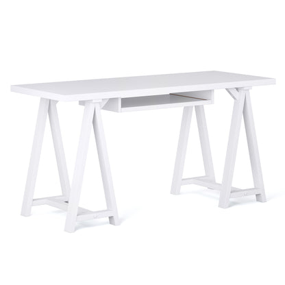 The Sawhorse - Handcrafted Desk features a modern white rectangular top, open shelf underneath, and two trestle-style legs on each side joined by horizontal supports.