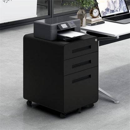 A 3 Drawer Mobile File Cabinet with a 5-wheel anti-tilting design, made of cold rolled steel, sits under a desk in a bright office. A printer on top prints paper beside a modern desk with a laptop and plant. Suitable for Legal/Letter/A4 files.