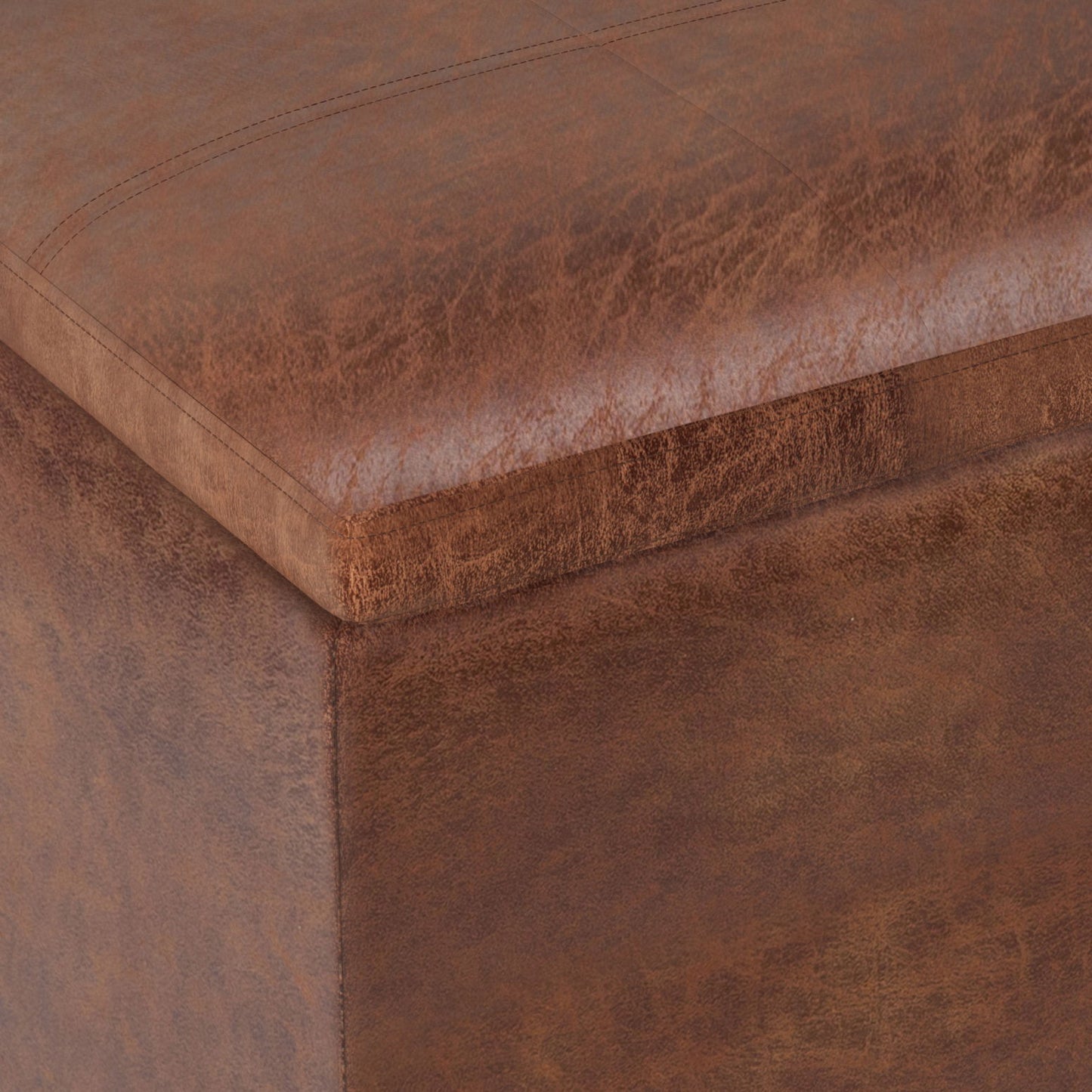 Close-up view of the Rockwood - Upholstered Cube Storage Ottoman With Tray, highlighting its brown leather texture, detailed stitching, and corner craftsmanship.