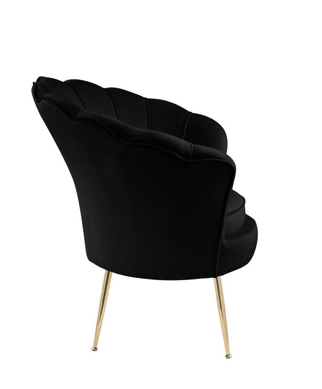 The Angelina Velvet Scalloped Back Barrel Accent Chair features a modern black design, scalloped backrest, and slim angled gold metal legs, shown from a rear side angle against a white background.