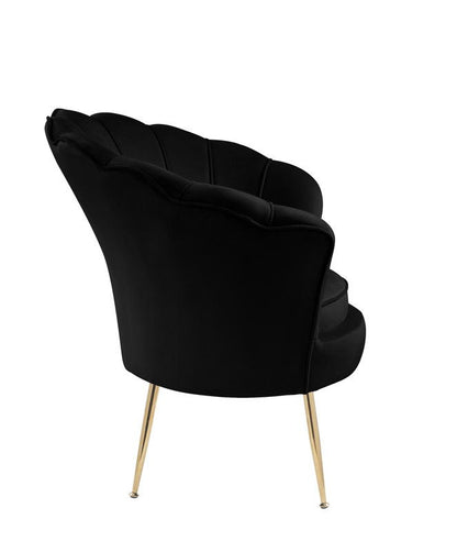 The Angelina Velvet Scalloped Back Barrel Accent Chair features a modern black design, scalloped backrest, and slim angled gold metal legs, shown from a rear side angle against a white background.