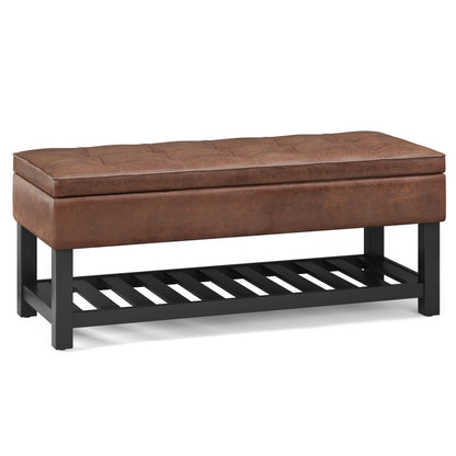 Cosmopolitan Storage Ottoman Bench with open bottom features a rectangular brown tufted leather seat, black wooden legs, and a slatted lower shelf for added storage.