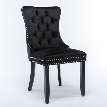 The Nikki set features two modern, high-end dining chairs with black velvet upholstery, tufted backs, silver nailhead trim, and solid wood legs, showcased against a plain white background.