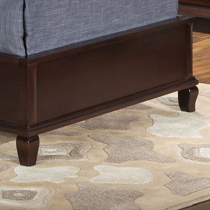 The Triton G9000A-TB Twin Bed in Cappuccino, featuring a dark wood finish and tapered legs, sits on a beige and cream patterned rug.