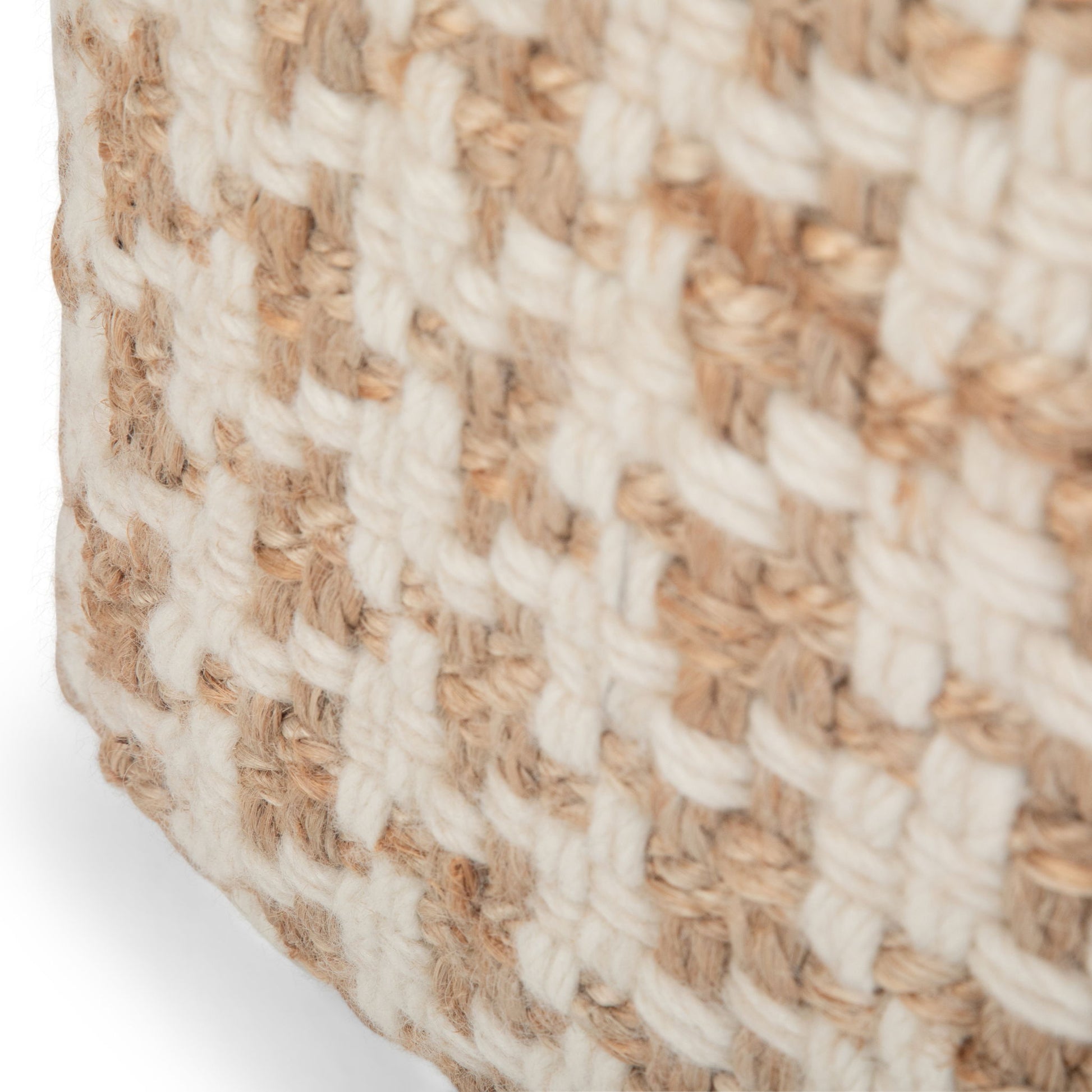 Close-up of the Cullen - Cube Pouf - Natural, highlighting its sturdy, rustic look with a textured checkered weave of thick tan and white fibers.