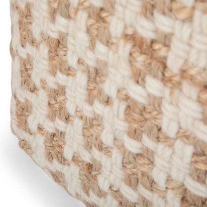 Close-up of the Cullen - Cube Pouf - Natural, highlighting its sturdy, rustic look with a textured checkered weave of thick tan and white fibers.