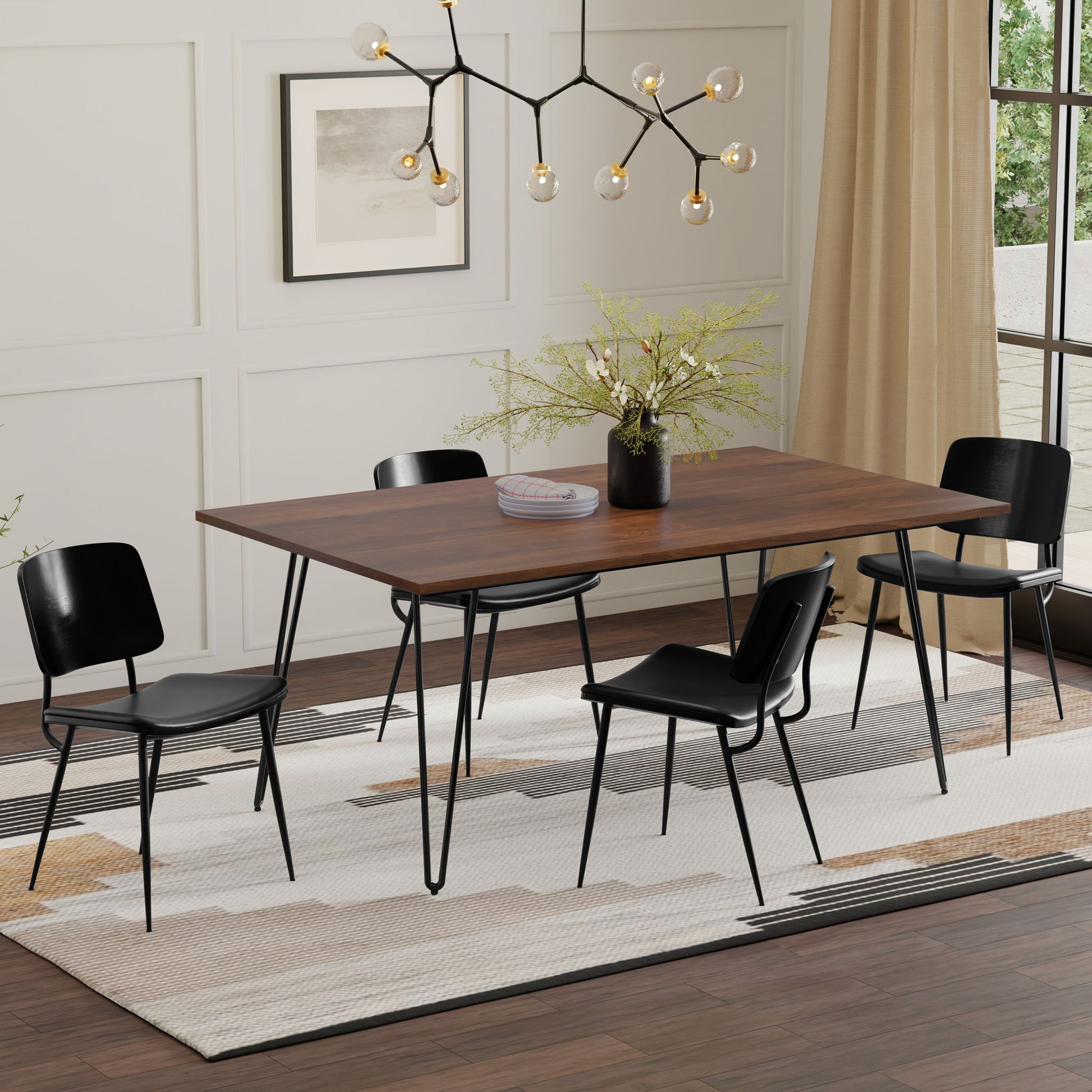 A modern dining room featuring the Hunter Square Tabletop Dining Table, four black chairs, a geometric chandelier, framed wall art, beige curtains, and a large abstract-patterned rug under the table.