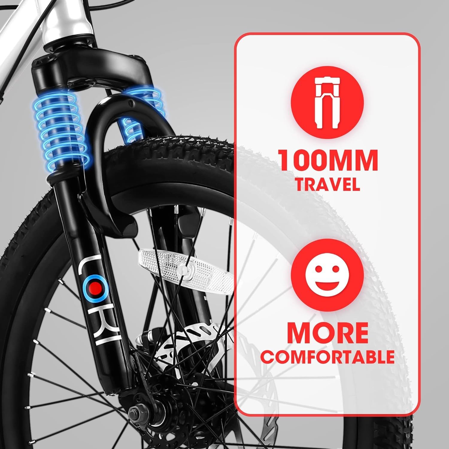 Close-up of the S20101 20" Kids' Bike front suspension fork with blue springs, featuring bold "100MM TRAVEL" and "MORE COMFORTABLE" text alongside icons on a red and white panel. Suitable for boys and girls ages 8-12.