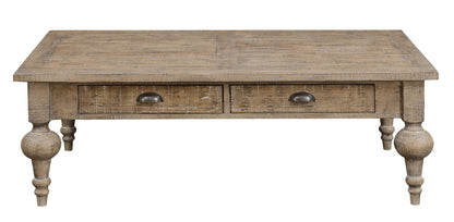 The Ludin Coffee Table in taupe features a rustic wooden design with a distressed finish, two front drawers with metal handles, and turned legs.