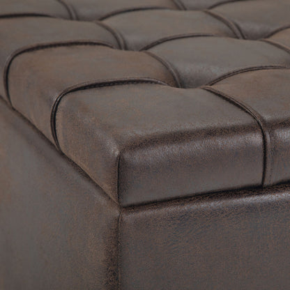 Close-up of the Harrison - Large Coffee Table Storage Ottoman featuring brown, tufted faux leather with visible stitching and detailed cushioned surface and sides.