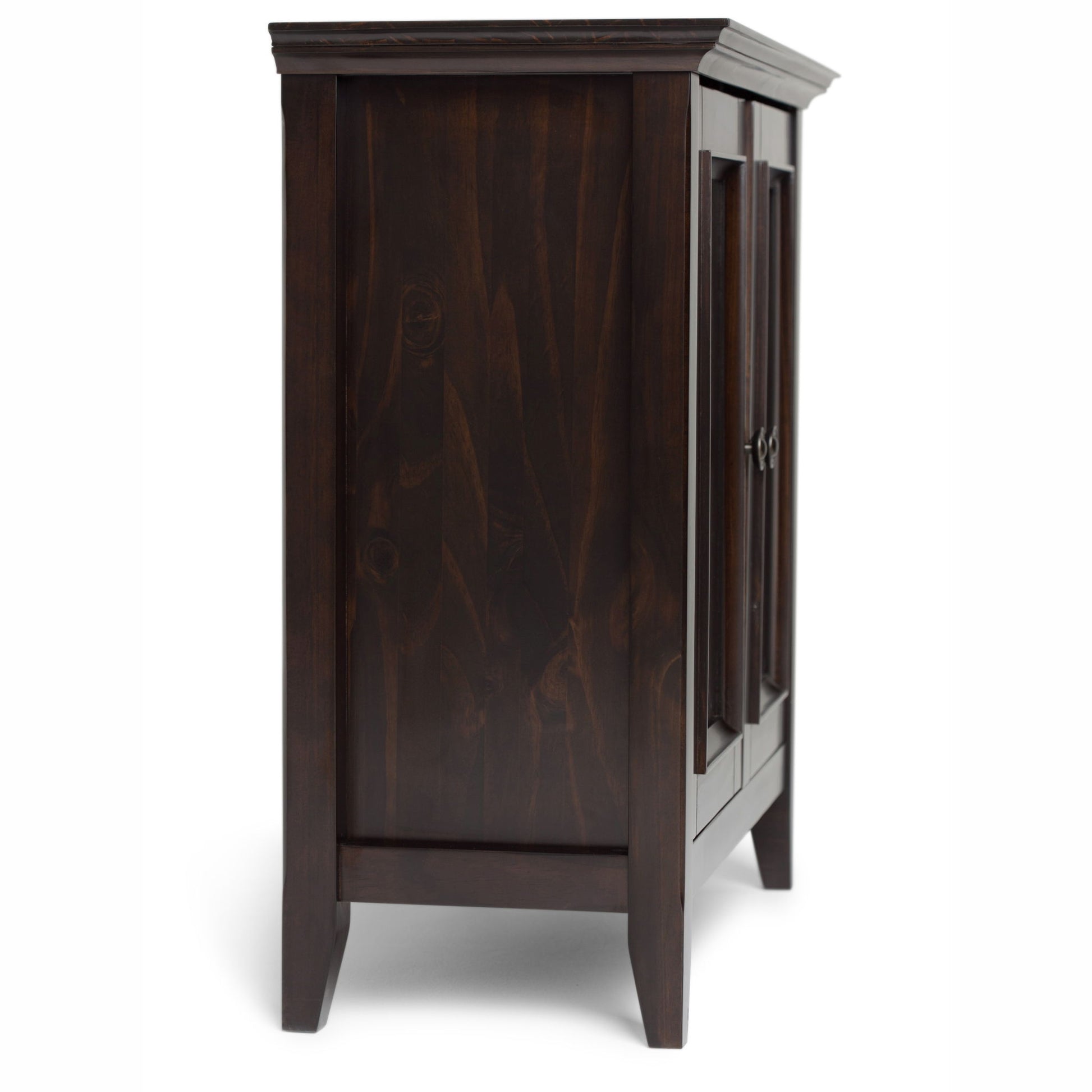 Side view of the Amherst - Handcrafted Low Storage Cabinet in dark wood, featuring paneled sides, raised legs, and two closed doors with metal handles, set against a plain white background.