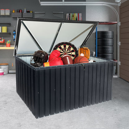 An open Metal Storage Box Store Large Outdoor Use - Black sits in a garage, displaying sports gear like a basketball, football, baseball helmet, boxing gloves, and a dartboard. Shelves and stacked tires are in the background.
