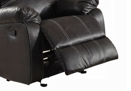 A close-up of the Zuriel - Synthetic Leather Recliner Chair in black, showing its extended footrest and contrasting white stitching along the seams.